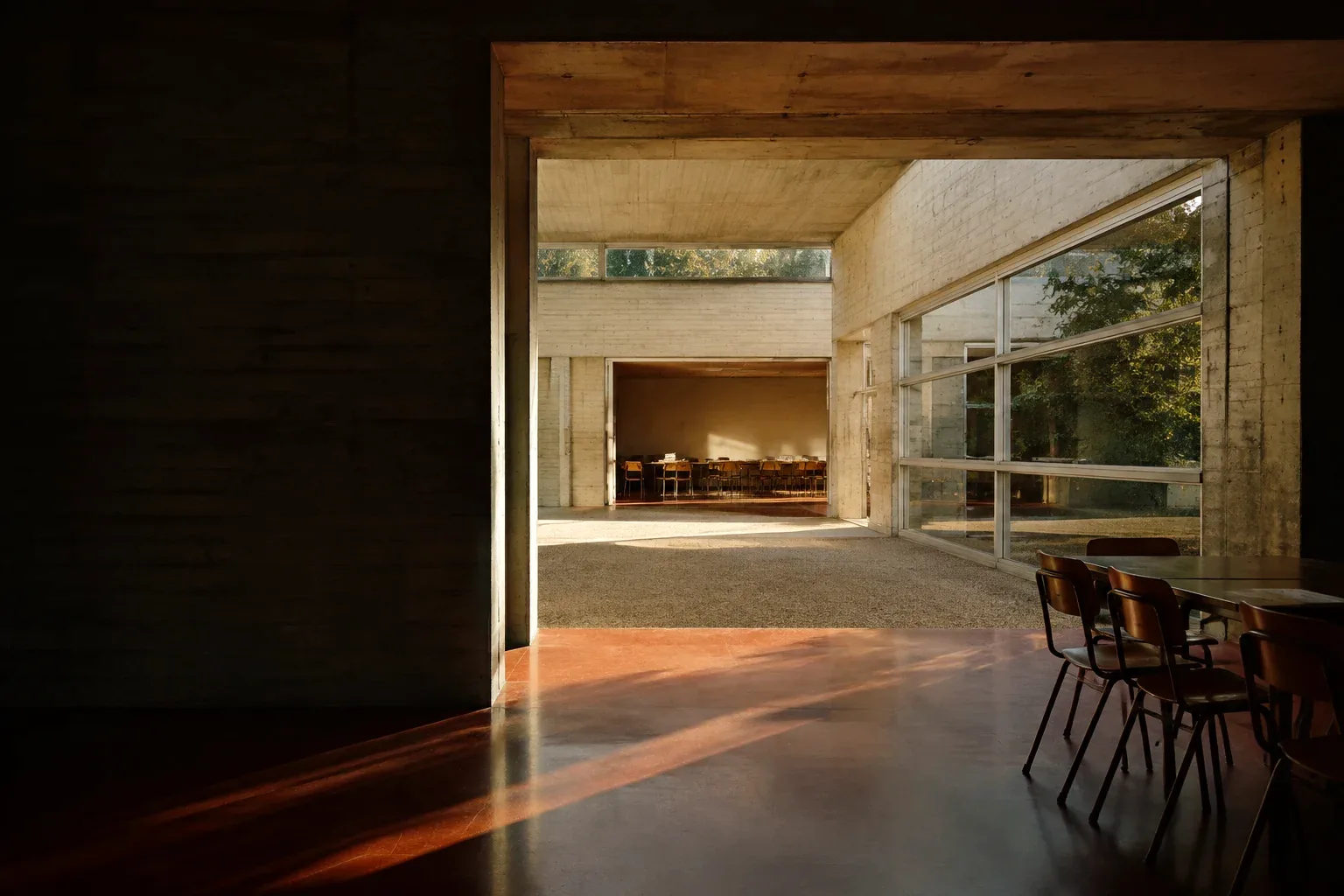 Afternoon light through an imagined learning center, with classrooms beyond a concrete passage.